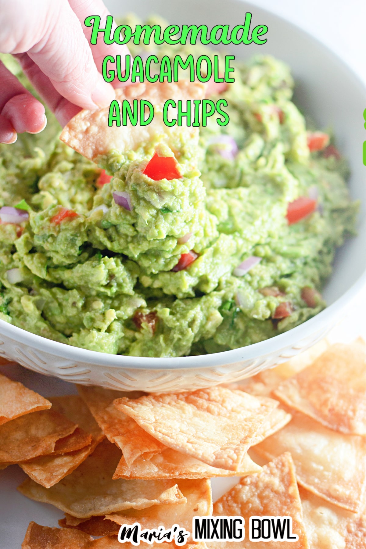 homemade guacamole in a white plate surrounded tortilla chips