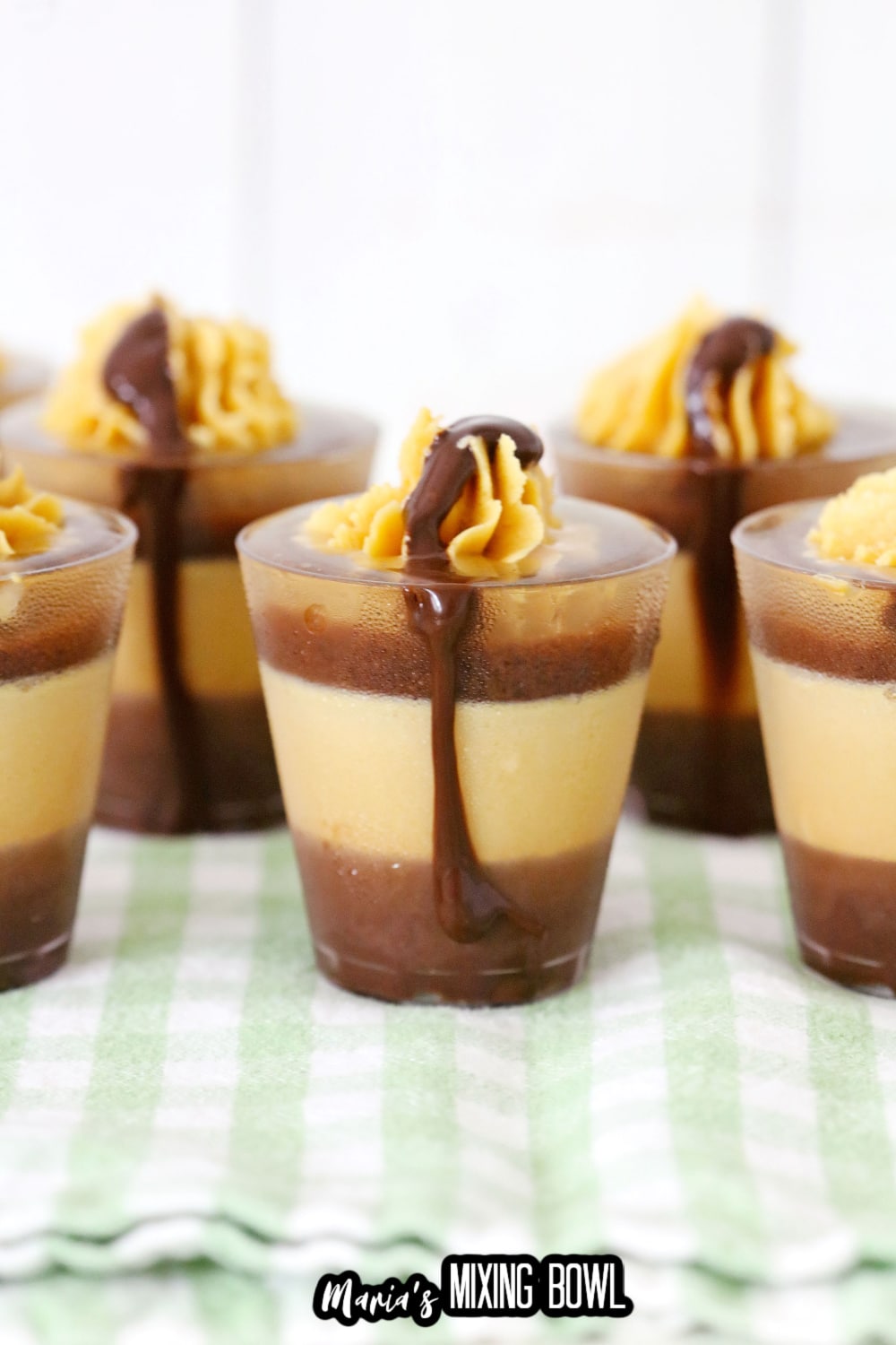 peanut butter cup shots on a green and white kitchen towel