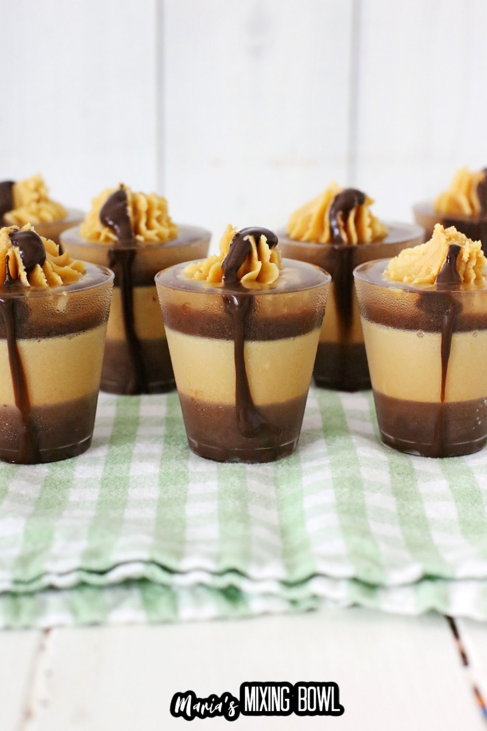 peanut butter cup shots on a green and white kitchen towel