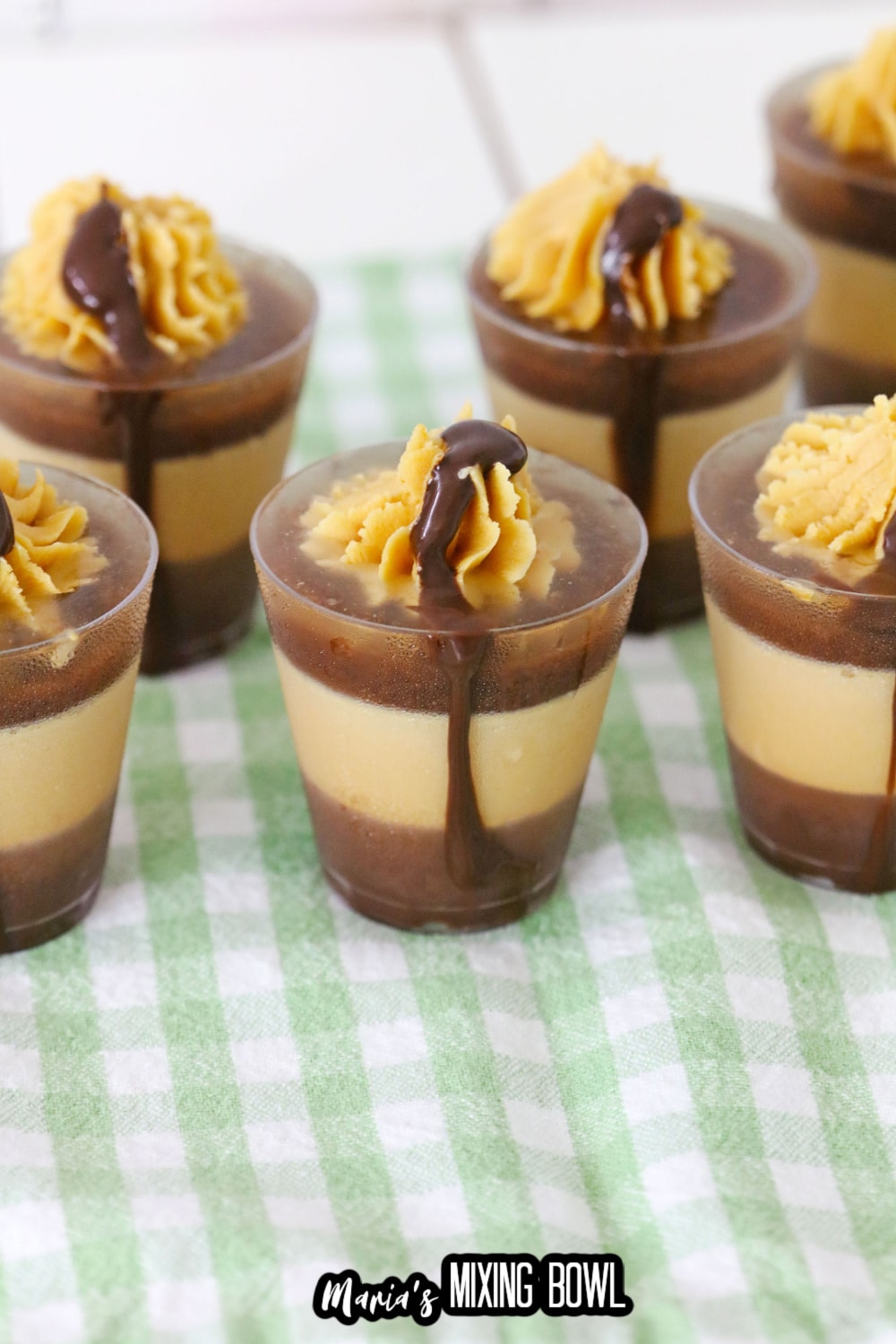 peanut butter cup shots on a green and white kitchen towel