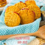 peanut butter and jelly cookies in a baking pan that is lined with a blue kitchen towels