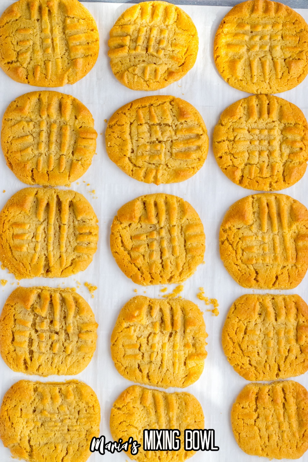 peanut butter cookies on a parchment lined baking sheet