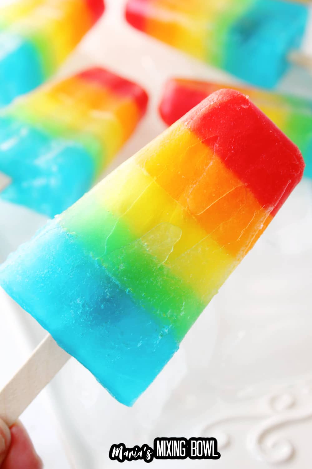 rainbow popsicle held in the air