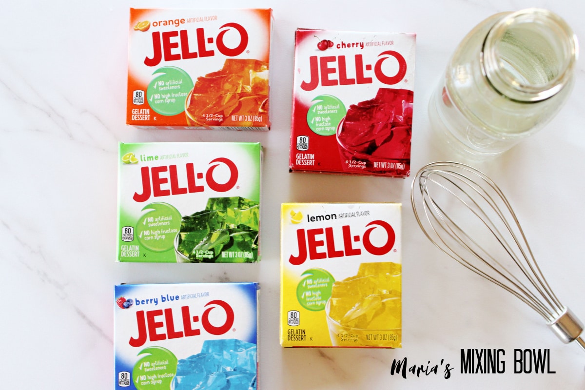 boxes of orange, red, lime, blue, and lemon jello on a white background