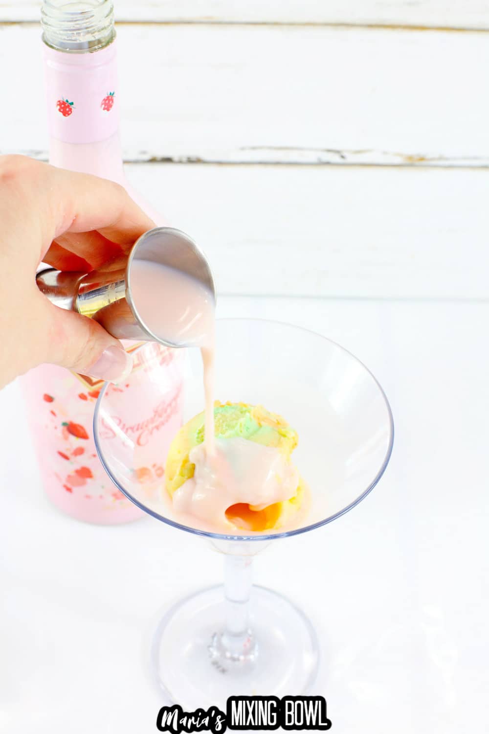 strawberry Bailey's being poured into a martini glass