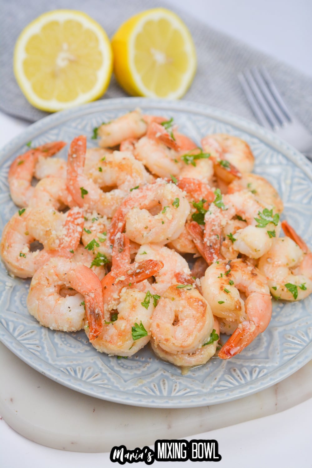 light blue and white plate full of shrimp scampi