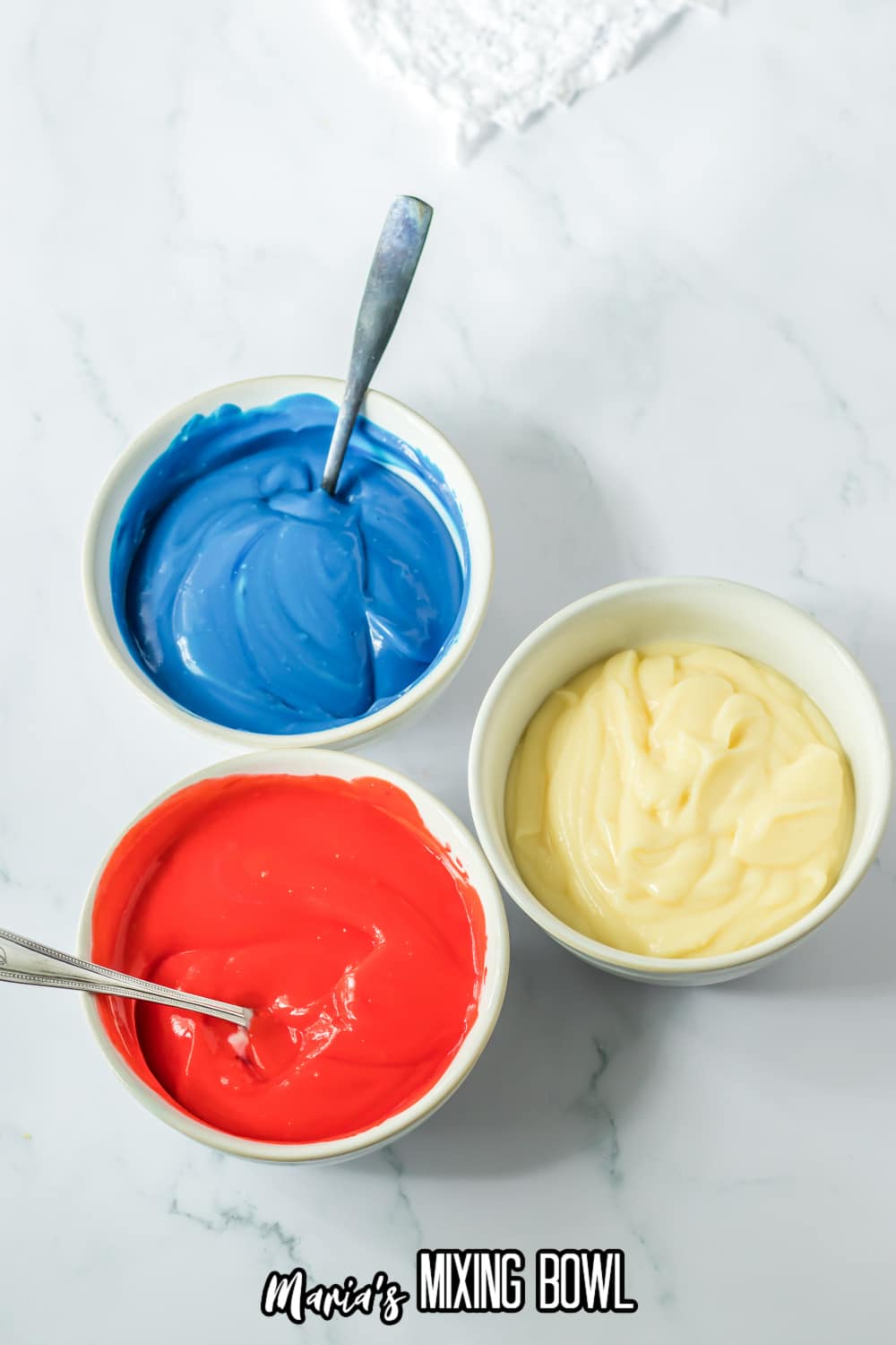 small bowls filled with red, blue, and white pudding