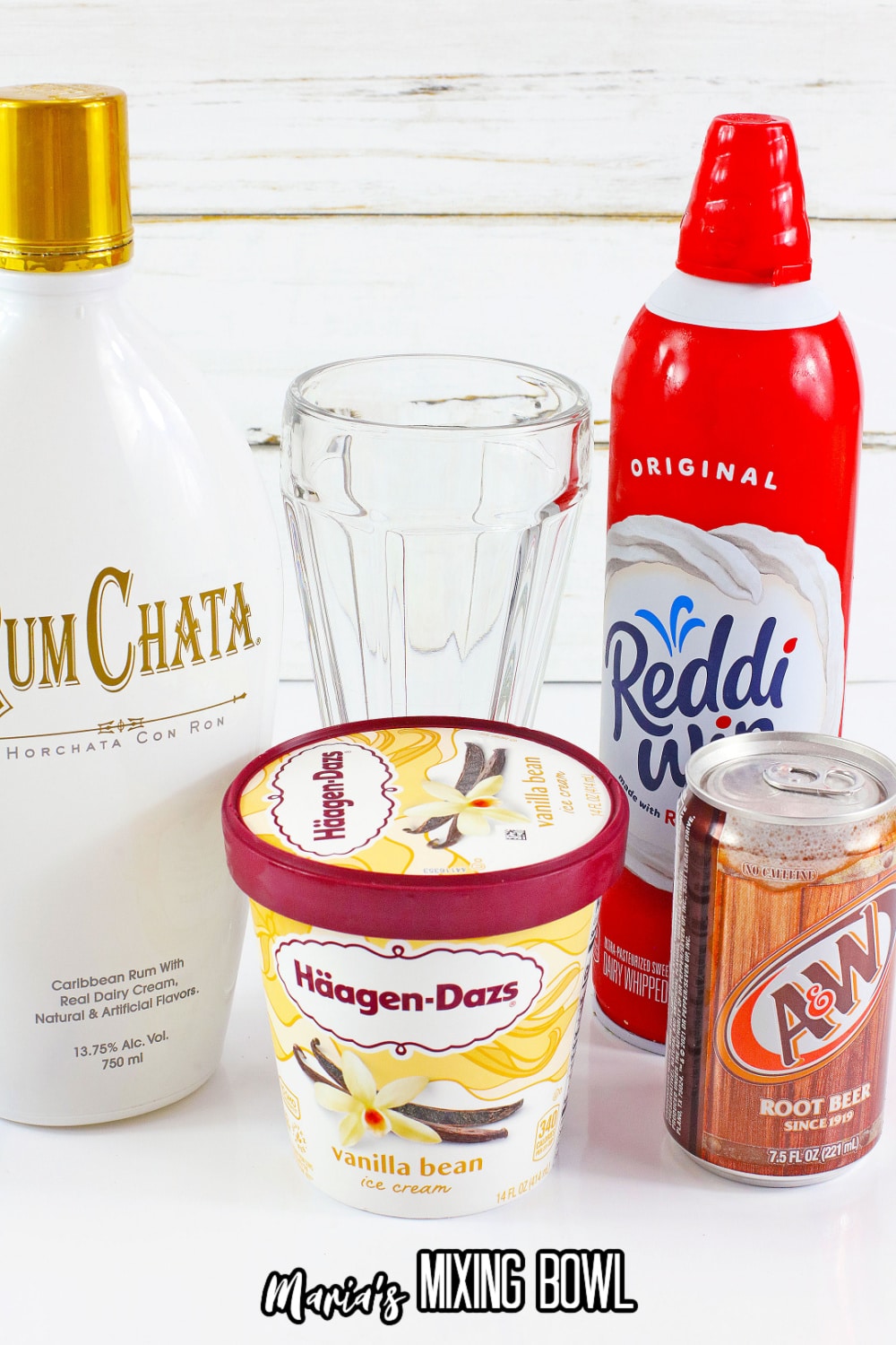ice cream, rum chata, whipped cream, and a can of root beer on a white background