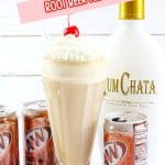 milkshake glass filled with a root beer float topped with whipped cream and a cherry