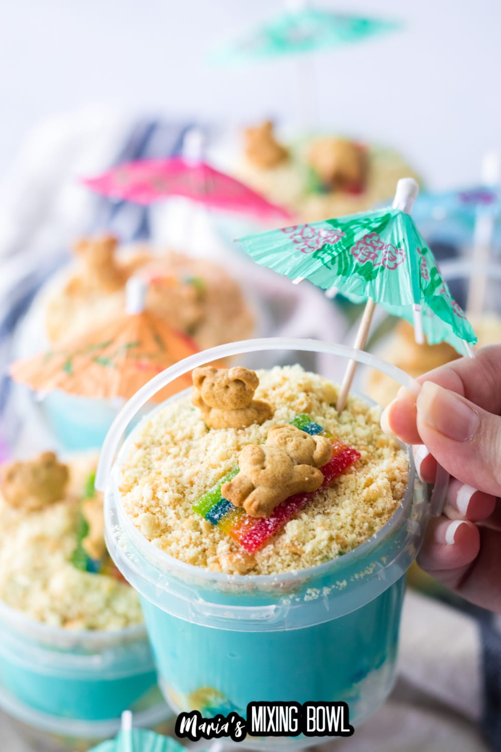 sand bucket dessert held in the air in a woman's hand