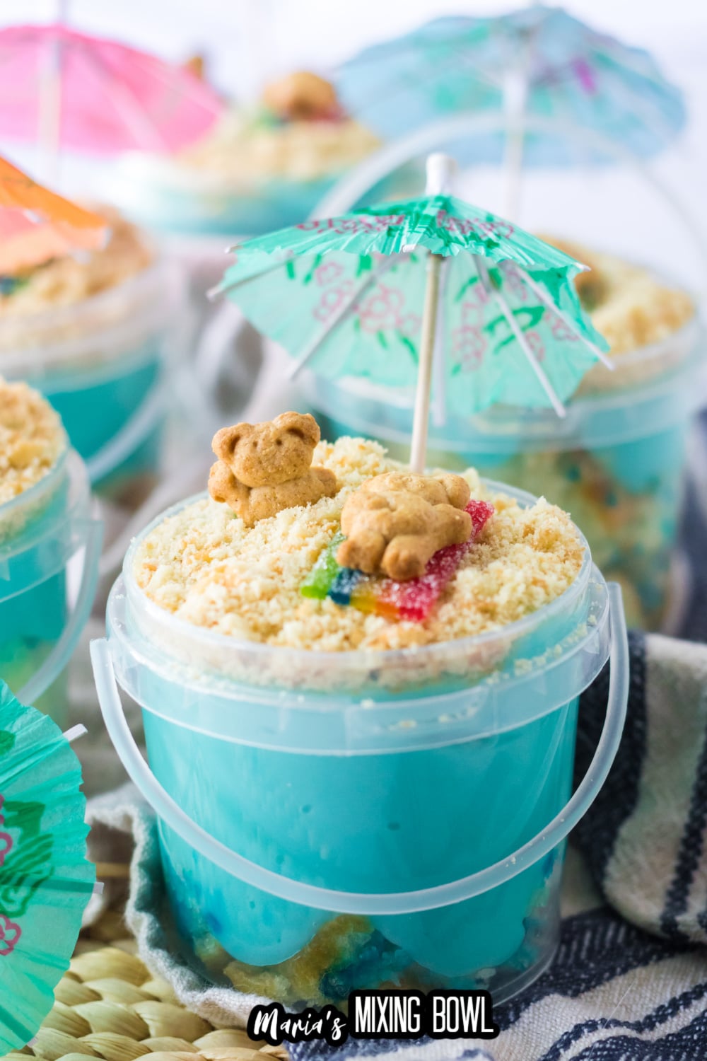 sand bucket dessert in a plastic bucket on a blue and white kitchen towel