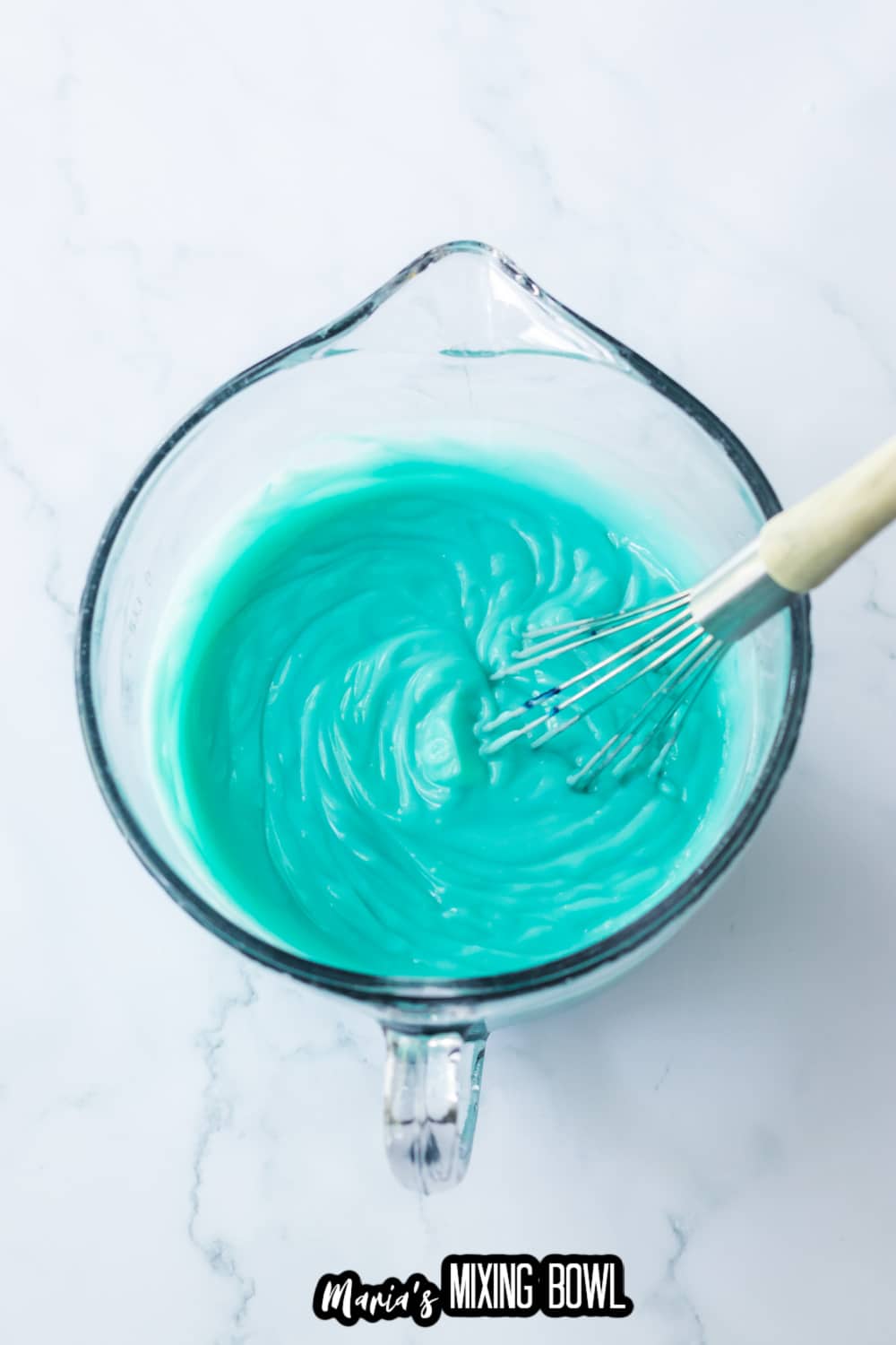 pudding in a glass mixing bowl that was been turned blue