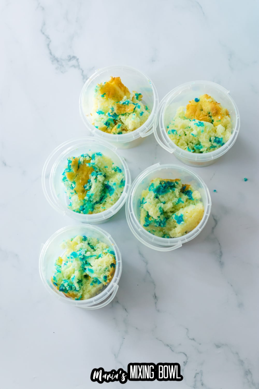 cake cut into pieces and placed in plastic bucket