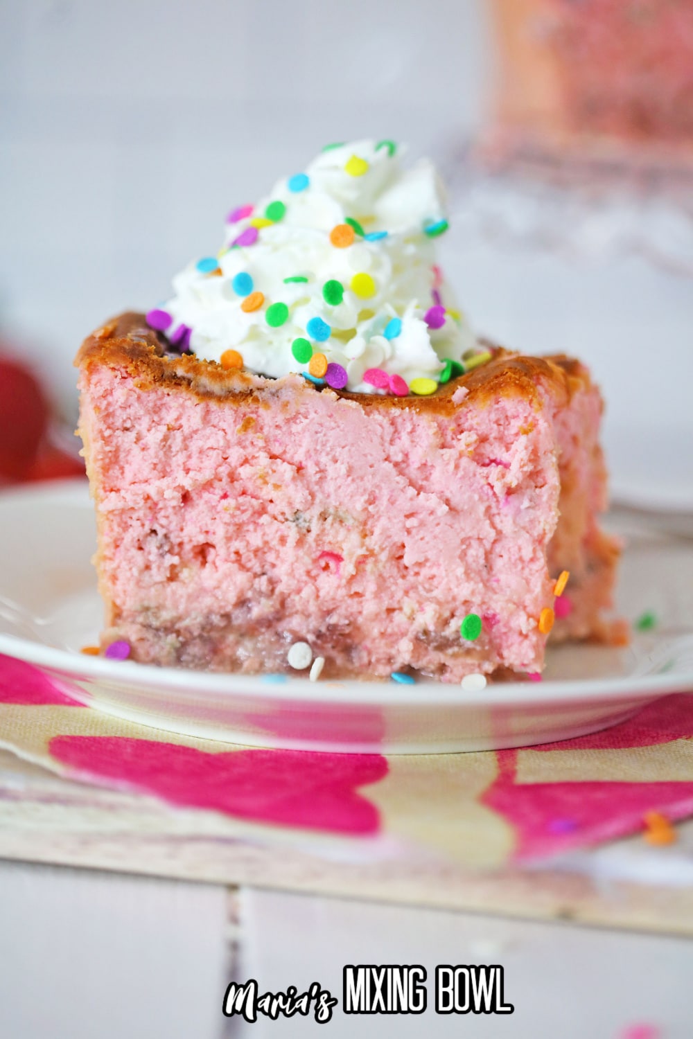 slice of confetti cheesecake on a white plate