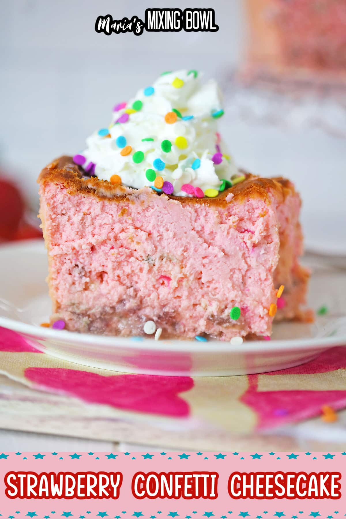 slice of strawberry confetti cheesecake on a white plate