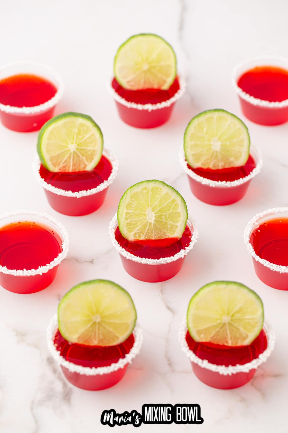 margarita shots rimmed with salt and a lime wedge