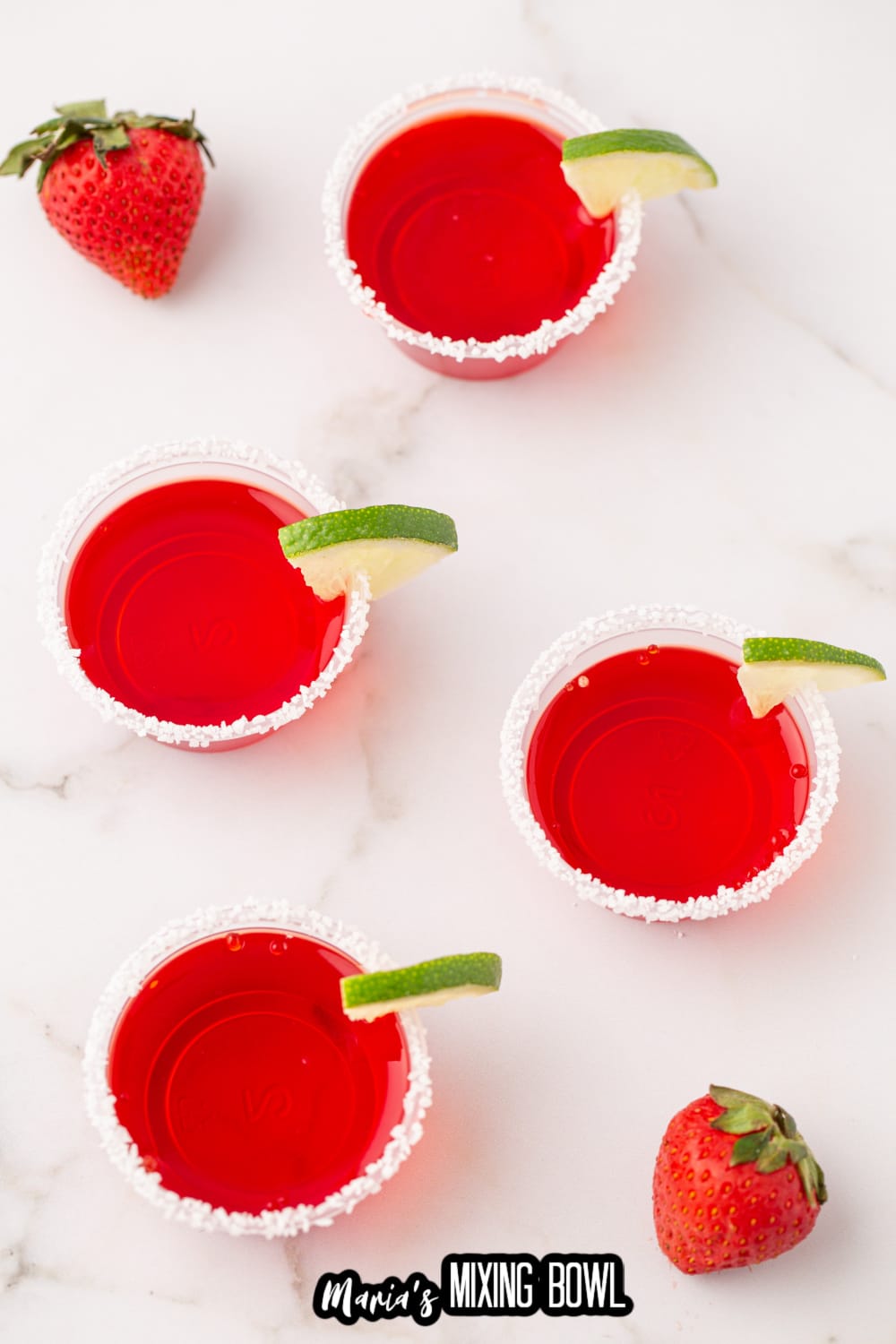 margarita shots rimmed with salt and a lime wedge