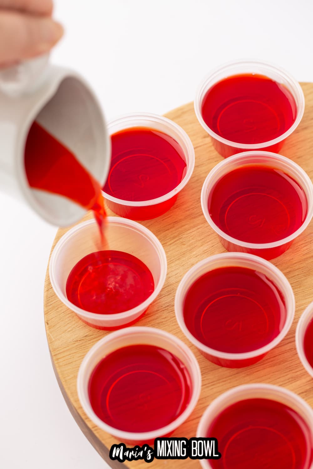 gelatin being poured into a shot glass
