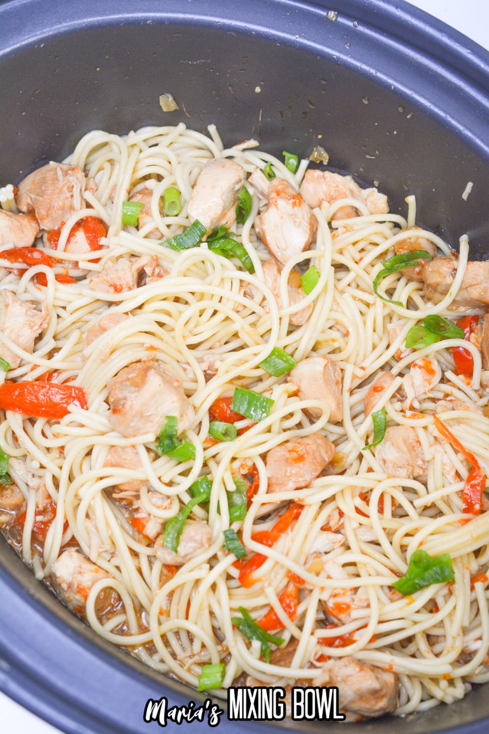 finished honey garlic chicken and noodles in a slow cooker