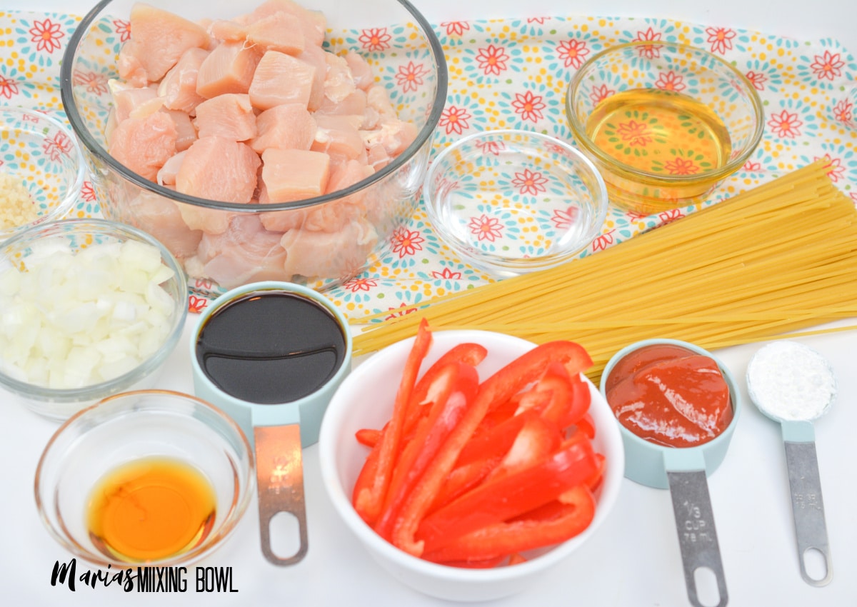 bowls of raw chicken breasts, diced onion, oil, peppers, ketchup, cornstarch, water, and soy sauce