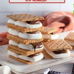 four baked smores stack on top of each other on a white plate