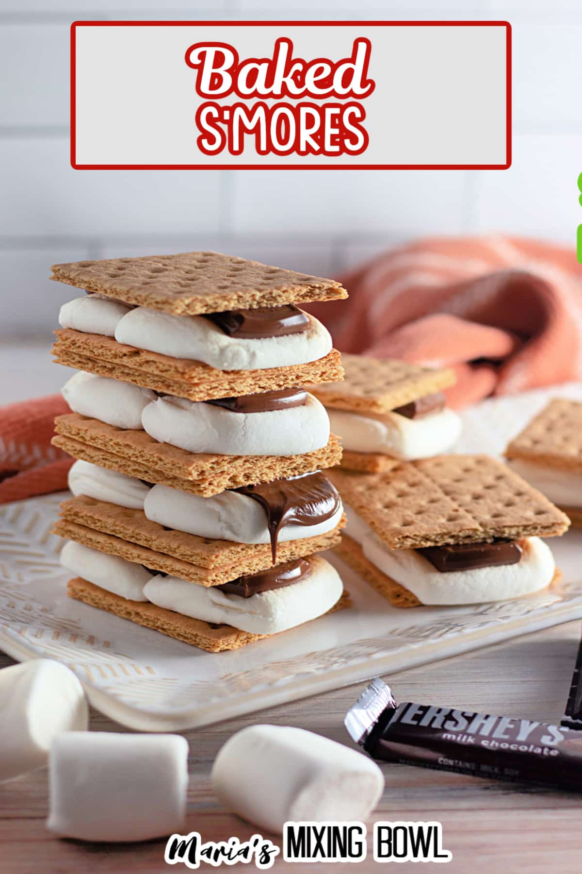 four baked smores stack on top of each other on a white plate