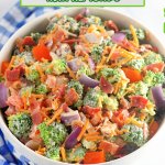 close up of a broccoli salad with almonds on a white background