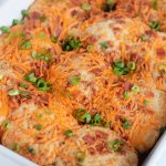 baked cheddar bacon ranch biscuits in a white casserole dish