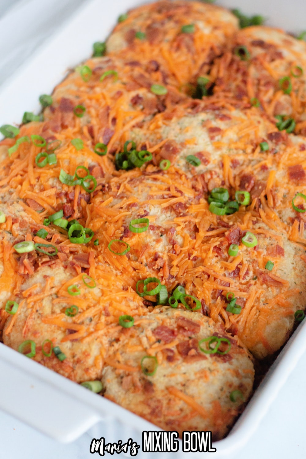 baked cheddar bacon ranch biscuits in a white casserole dish