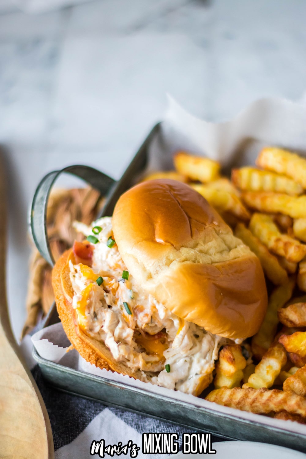 chicken bacon ranch sandwich on a serving tray with fries