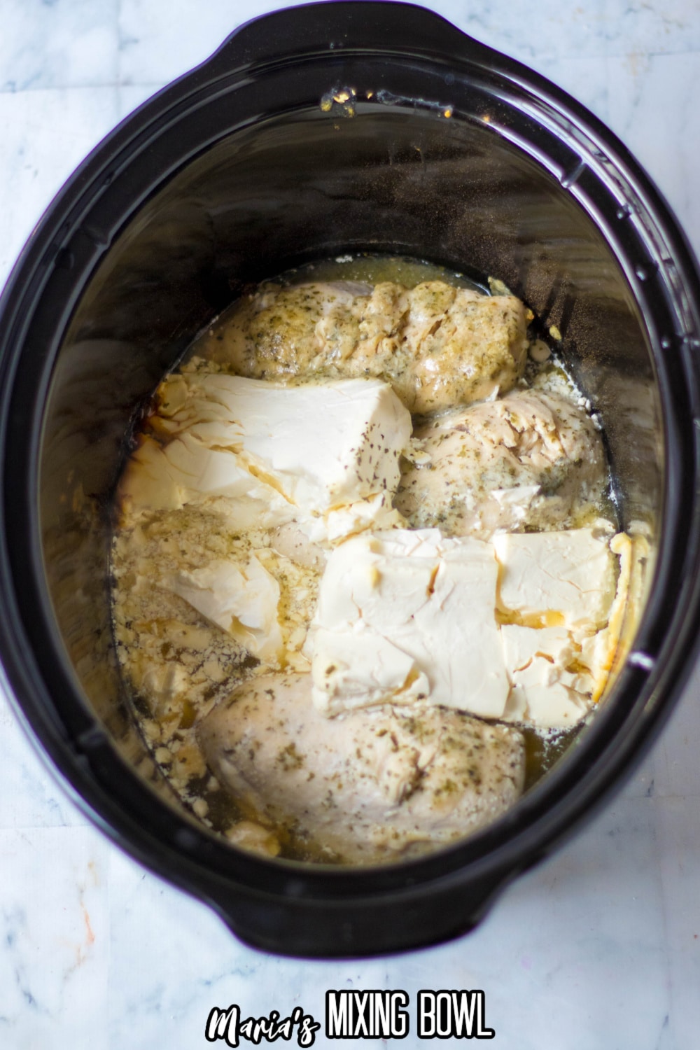 cooked chicken, ranch and cream cheese in a slow cooker