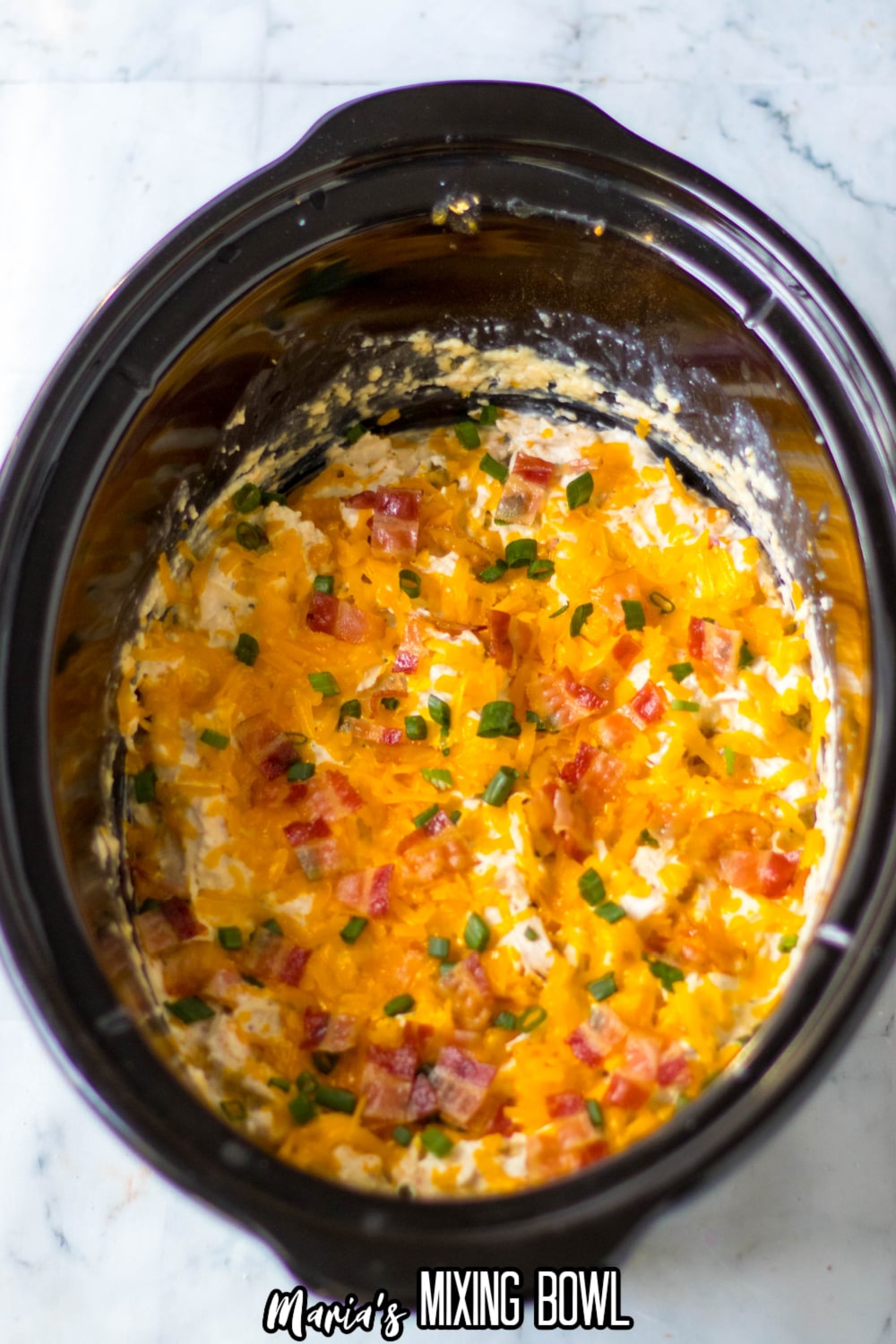crack chicken topped with melted cheddar cheese, bacon and green onions