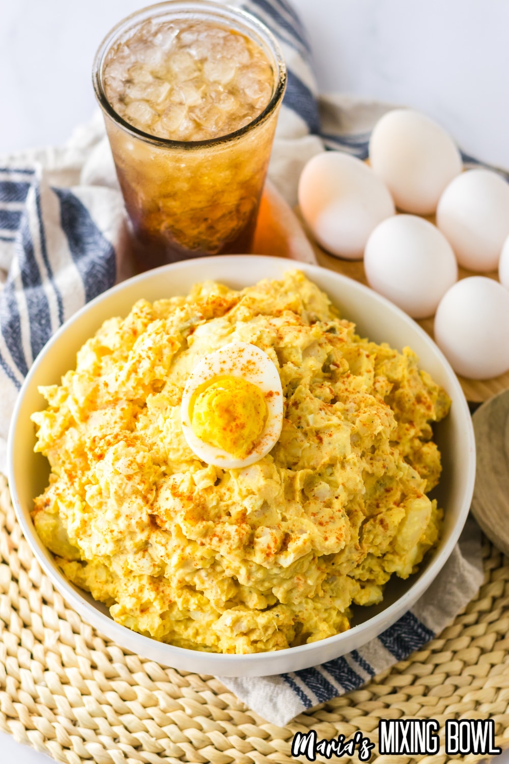 white bowl filled with deviled egg potato salad