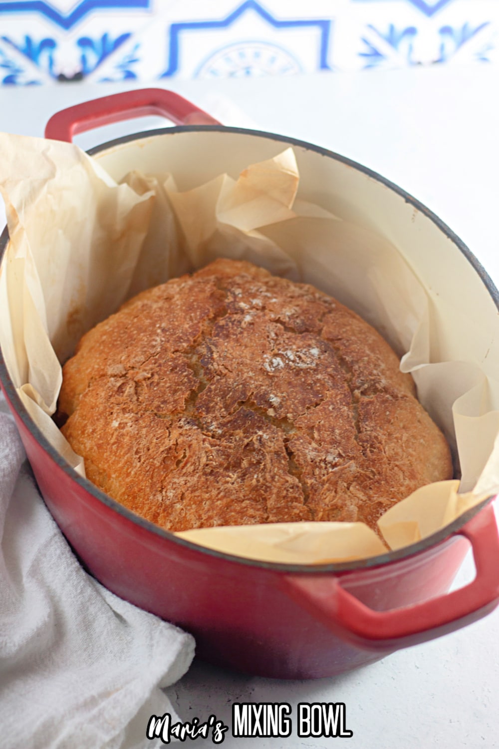 baked dutch oven bread in a parchment lined dutch oven