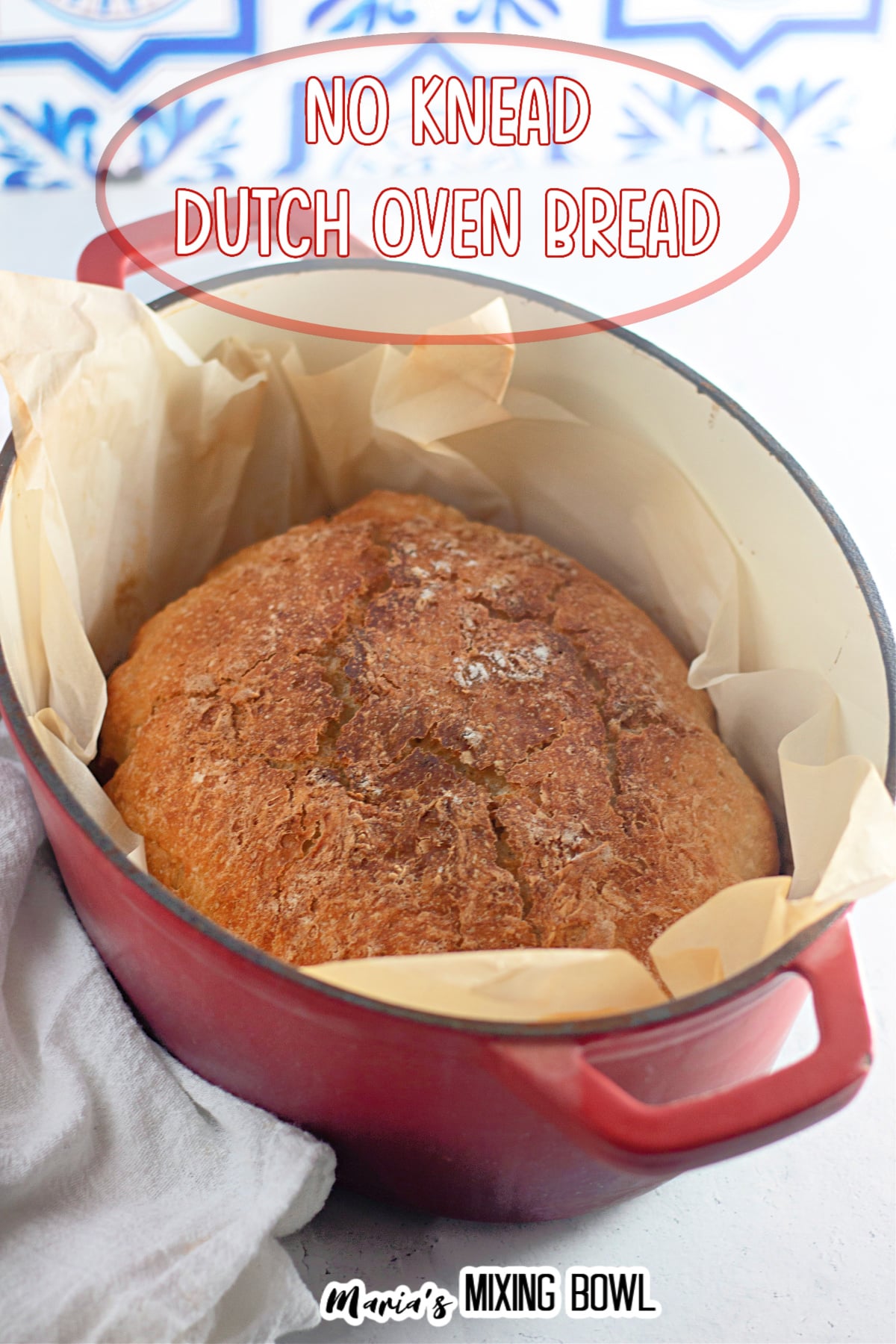 baked dutch oven bread in a parchment lined dutch oven