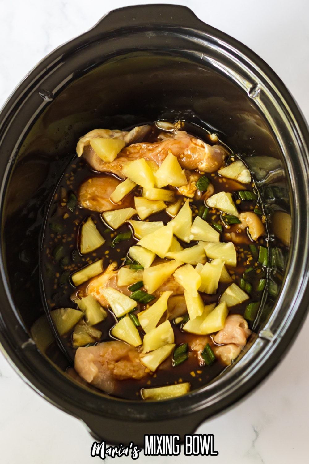 chicken, pineapple chunks, and hawaiian bbq sauce in a slow cooker