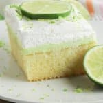 finished key lime poke cake in a glass baking dish topped with lime zest