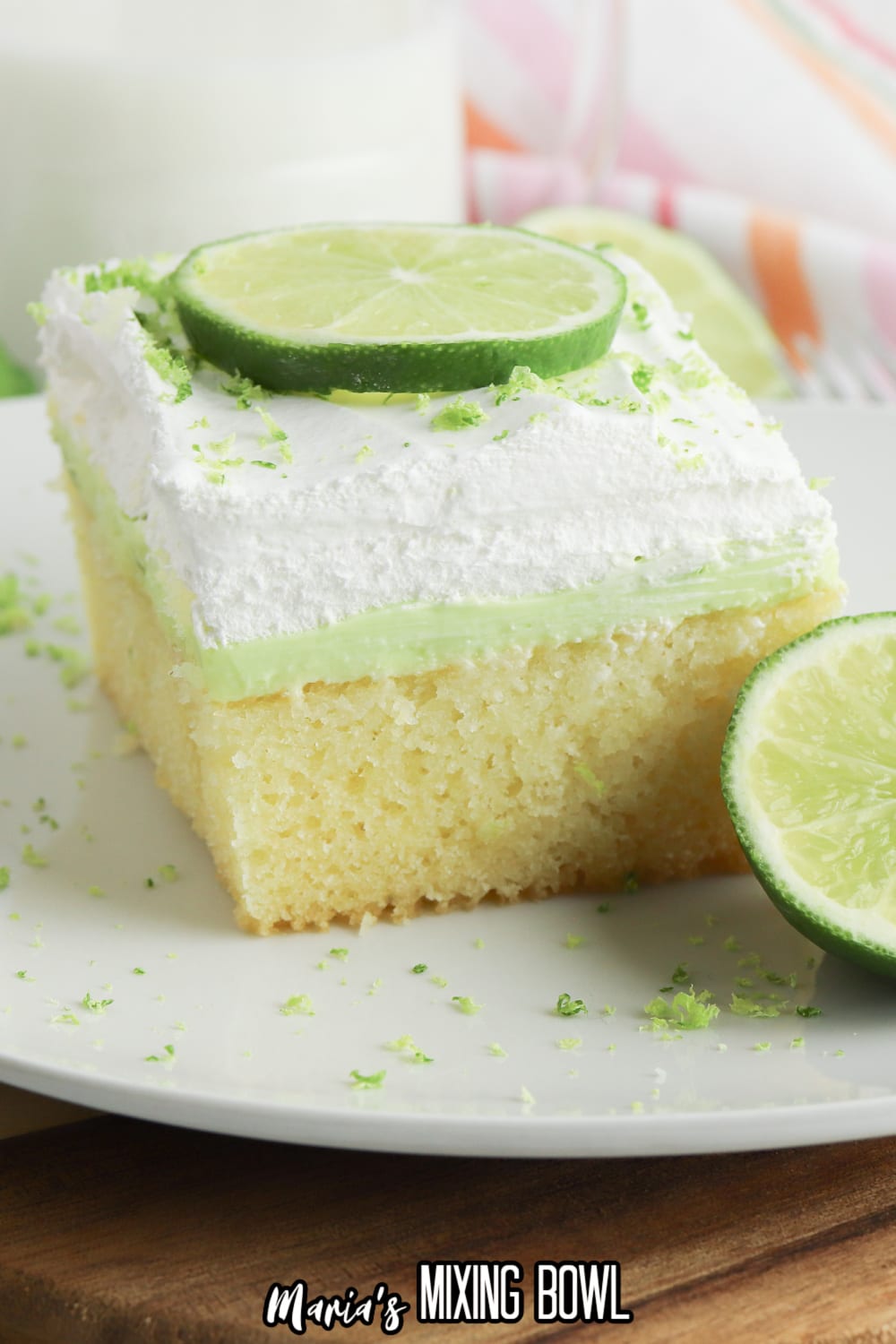 finished key lime poke cake in a glass baking dish topped with lime zest