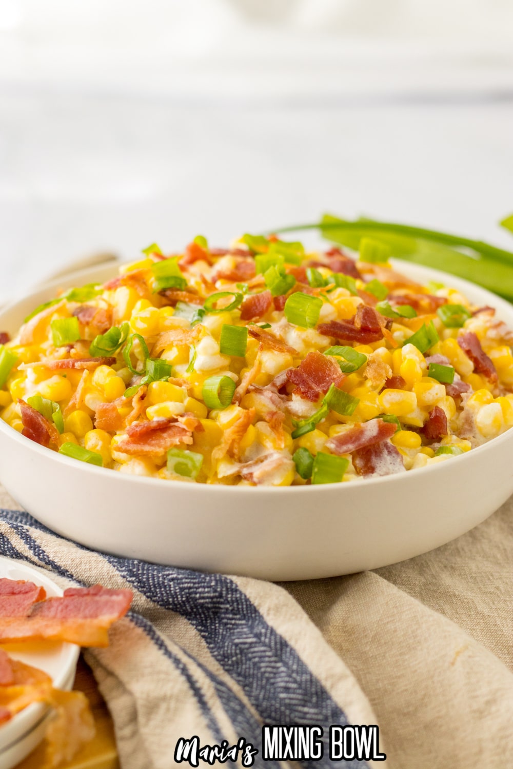 white bowl filed with loaded cream corn