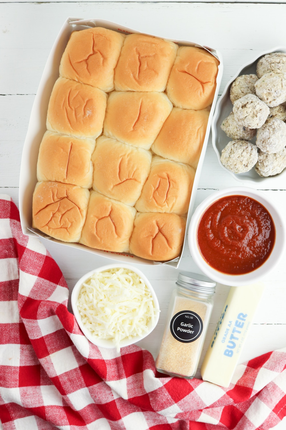 rolls, frozen meatballs, sauce, mozzarella cheese, garlic powder, and butter