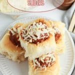 meatball sliders topped with mozzarella cheese on a white plate