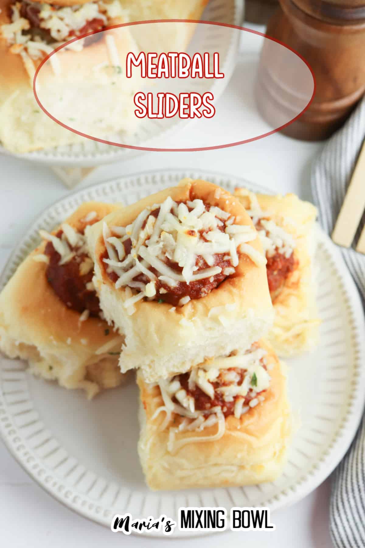 meatball sliders topped with mozzarella cheese on a white plate