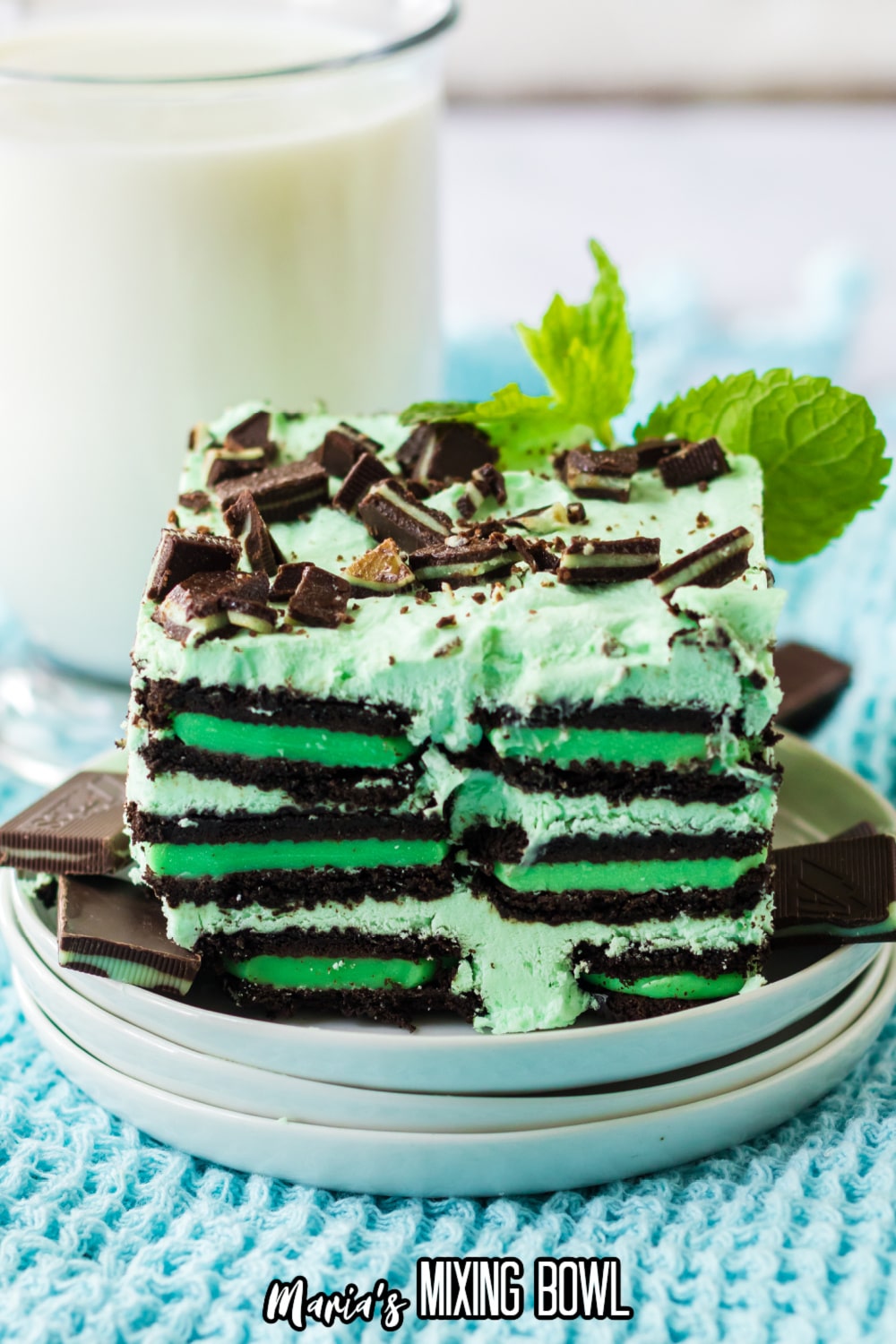 slice of mint chocolate icebox cake on a stack of small white plates