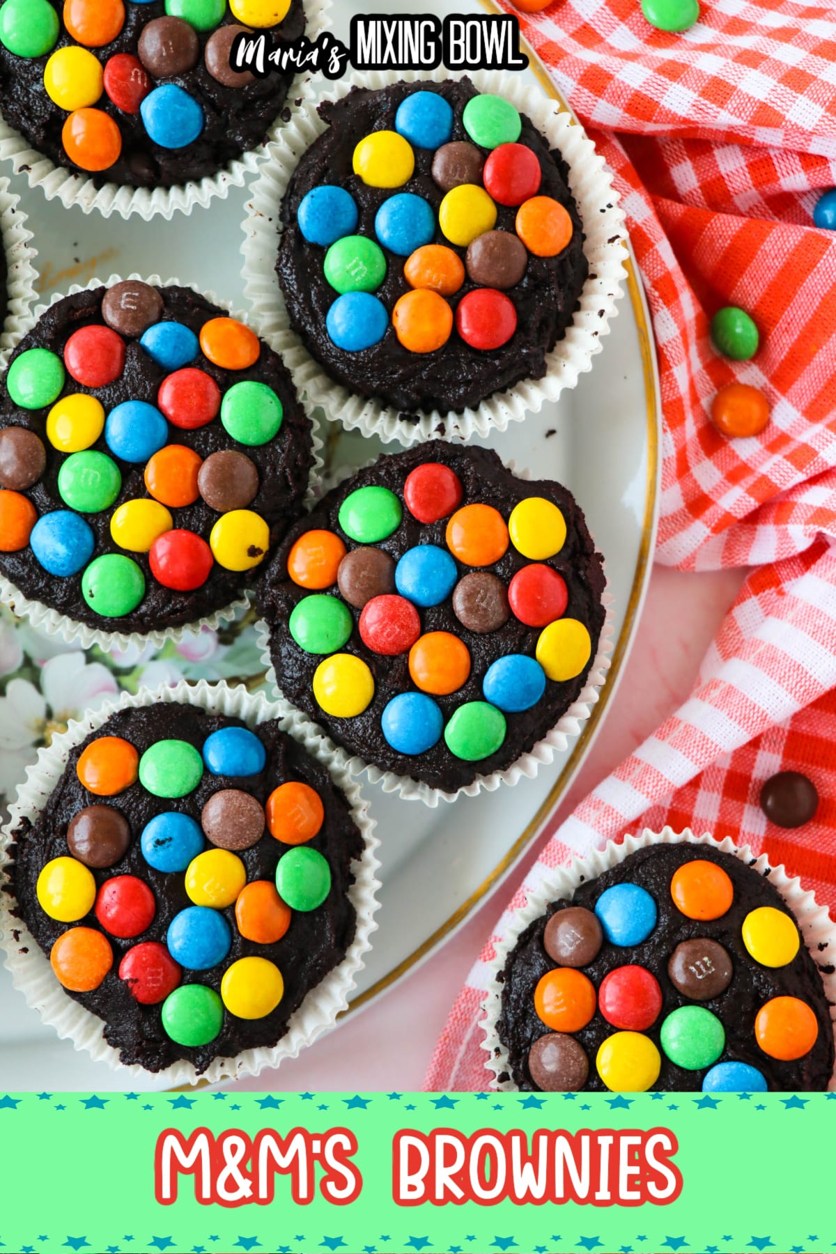 birds eye image of m&m brownies on a white plate with gold around the rim