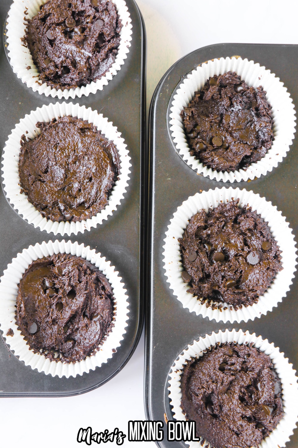 brownie batter in cupcake liners in a baking pan