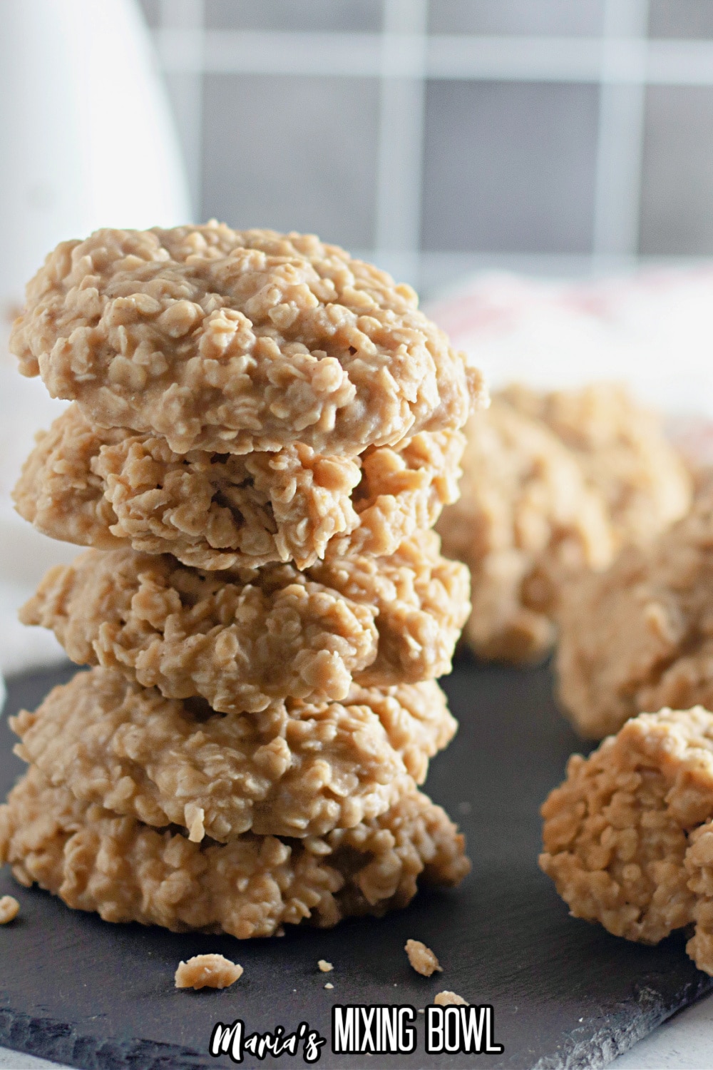 stack of five no bake peanut butter cookies on a slate gray stray