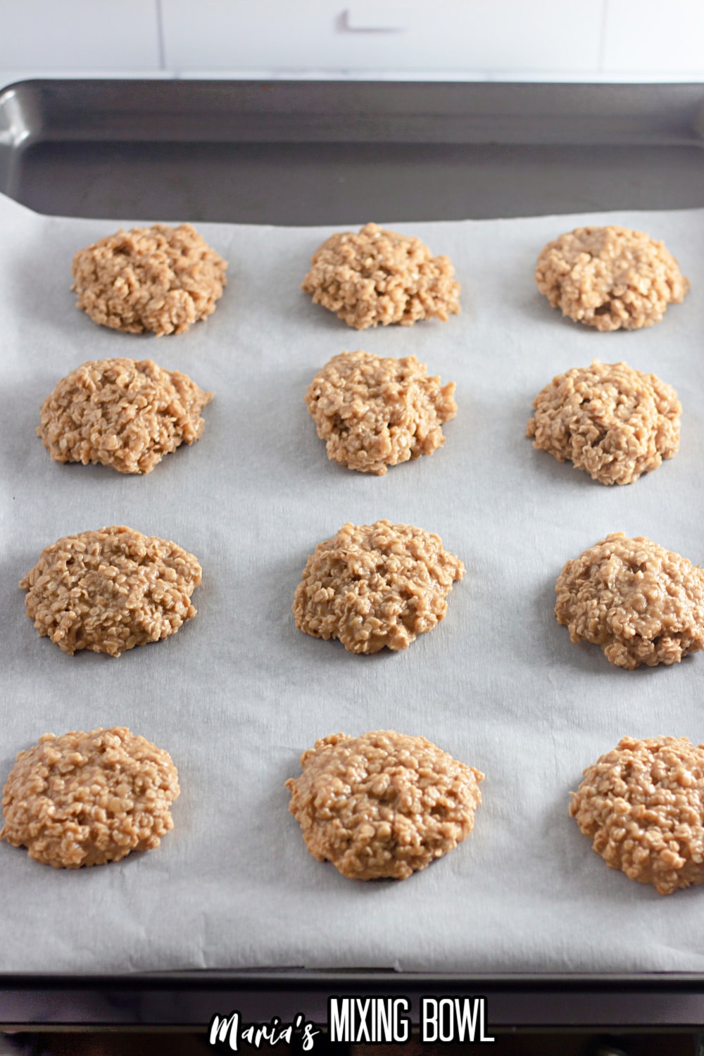 raw no bake cookies hardening on a parchment lined baking sheet