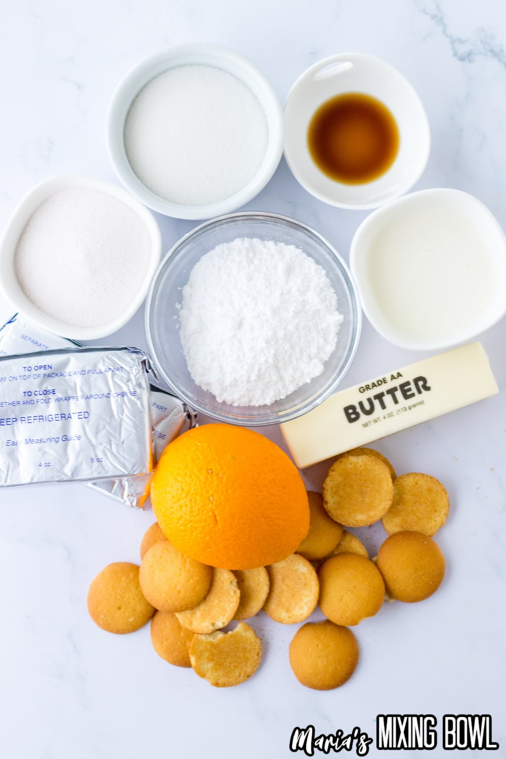 small bowls of gelatin, powdered sugar, sugar, vanilla extract, heavy cream, butter, cream cheese, an orange and vanilla wafers