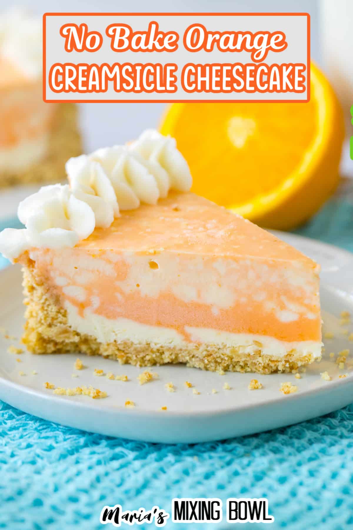 slice of orange cheesecake on a white plate on top of a bright blue kitchen towel