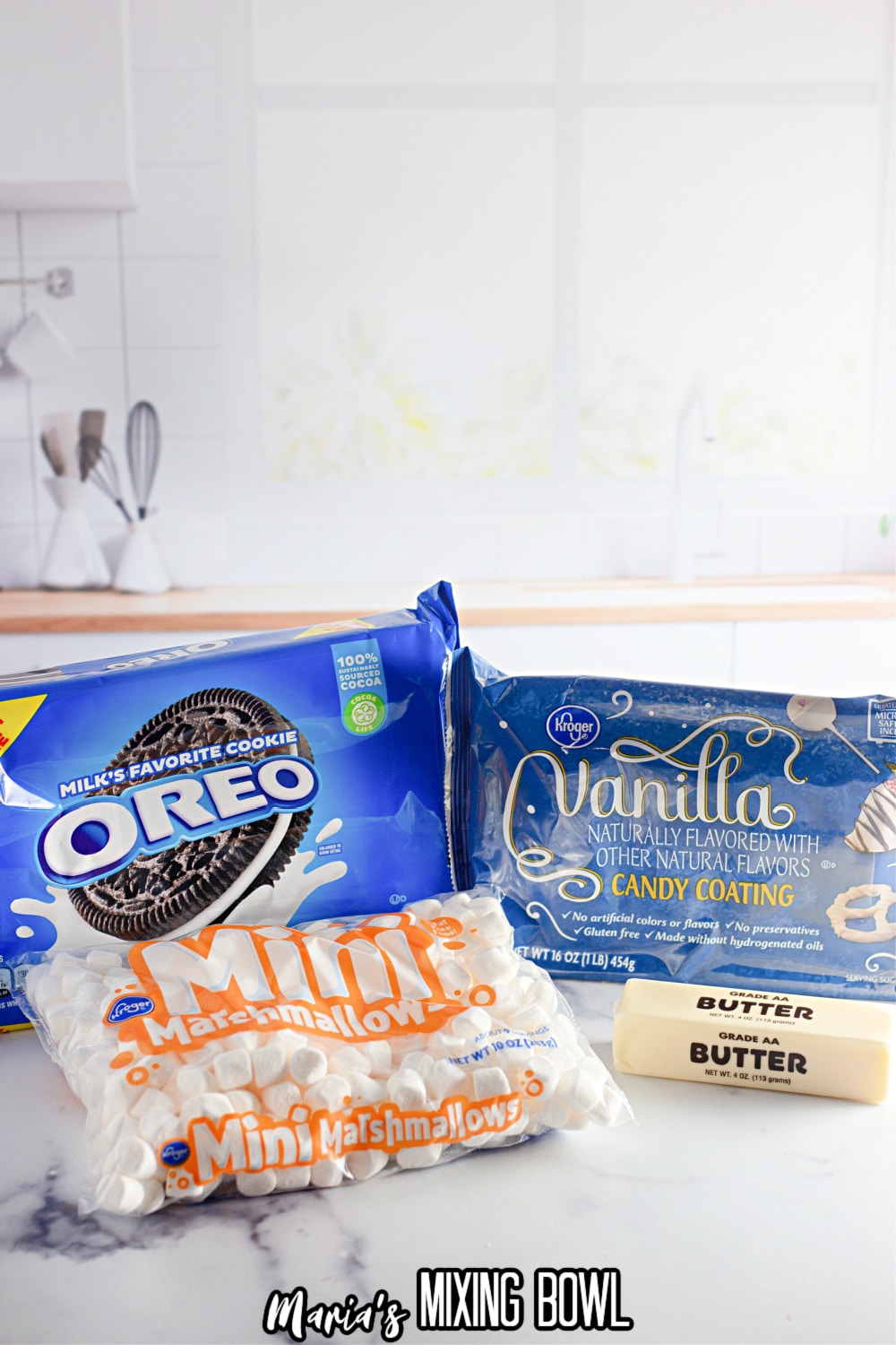 packages of oreo cookies, mini marshmallows, vanilla almond bark, and a stick of butter